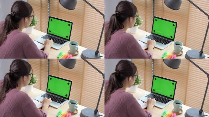 在家工作的女人绿屏笔记本电脑