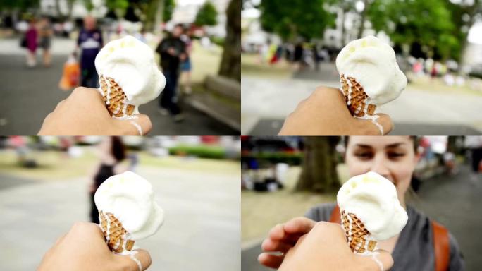 4k视频片段，一名男子拿着融化的冰淇淋蛋筒走来走去