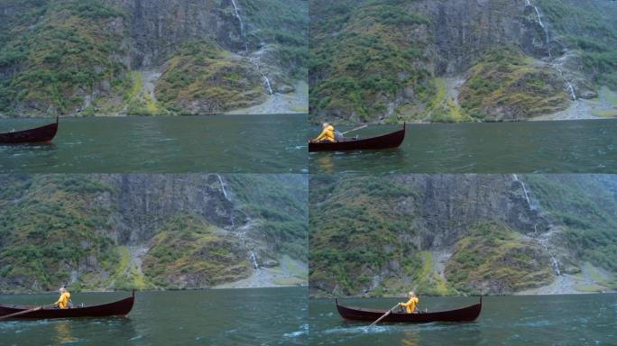 4k视频片段，一个无法识别的女人独自坐着，在Nordfjord的一个湖上划船