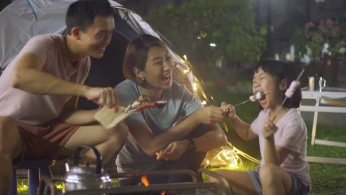 亚洲华人家庭在他们的房屋后院露营周末活动