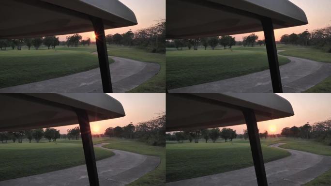 美丽的日落俯瞰黄金球场。高尔夫球场上的高尔夫球车，乡村高尔夫球场，绿色高尔夫球场，高尔夫假期。体育电