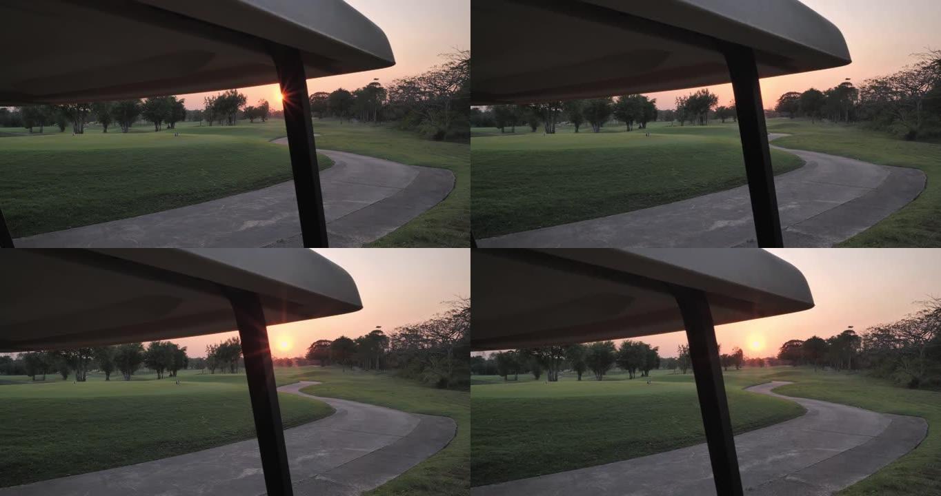 美丽的日落俯瞰黄金球场。高尔夫球场上的高尔夫球车，乡村高尔夫球场，绿色高尔夫球场，高尔夫假期。体育电