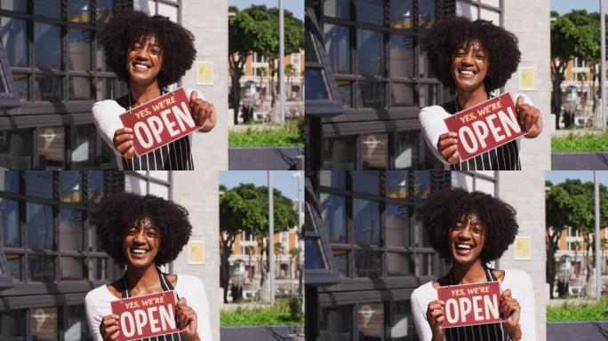 快乐的非裔美国女服务员打开标牌微笑着