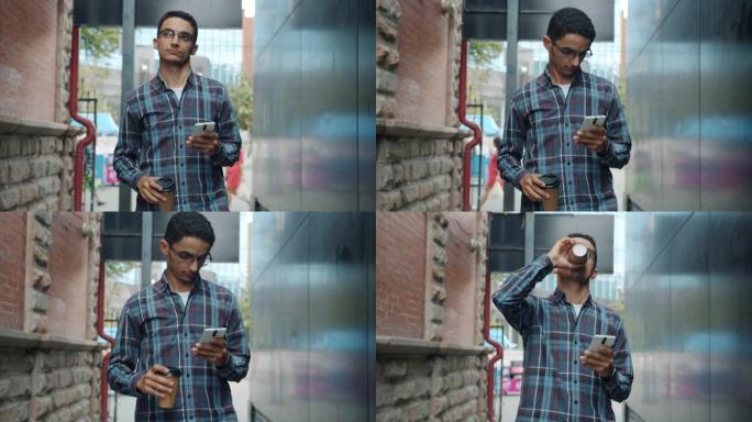 迷人的中东男子在户外散步时喝咖啡和使用智能手机的肖像