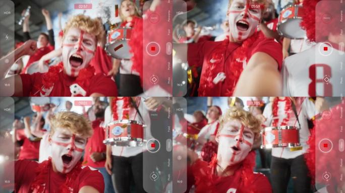 体育场体育赛事自拍POV相机应用程序肖像: 面部彩绘男子手持智能手机拍摄自己，为红队获胜欢呼，尖叫，