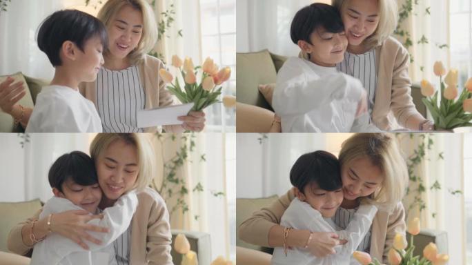 拥抱母亲的一束鲜花的亚洲男孩