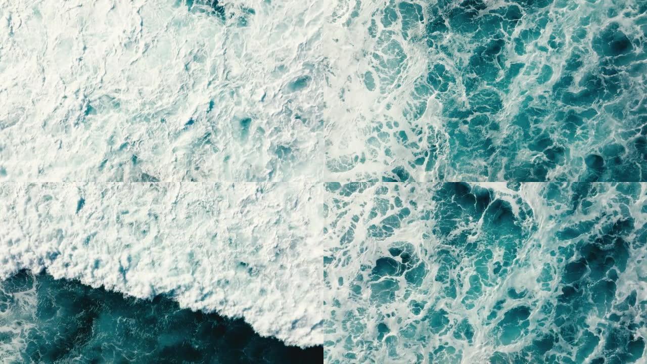 自上而下的鸟瞰图美丽的巨大蓝色海浪撞击和泡沫与白色洗涤背景