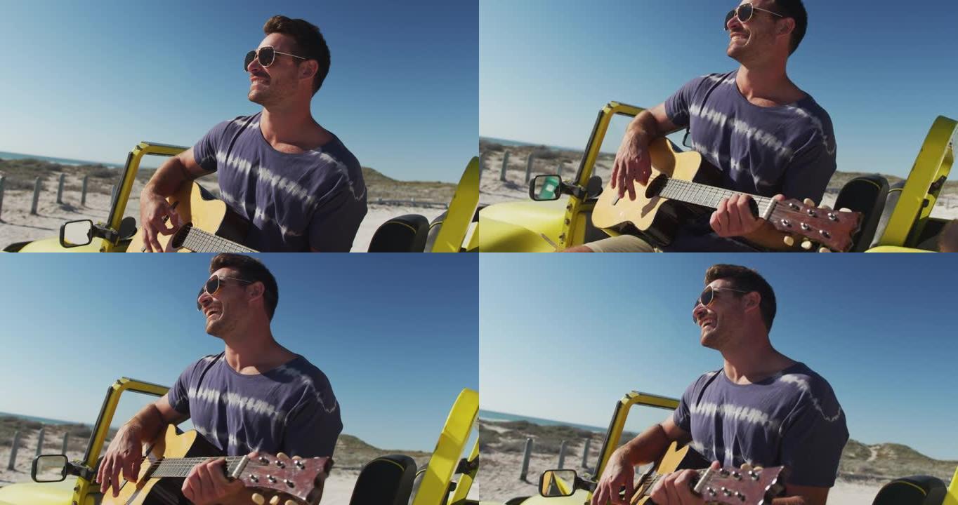 快乐的高加索人坐在海边的沙滩车里玩gguitar
