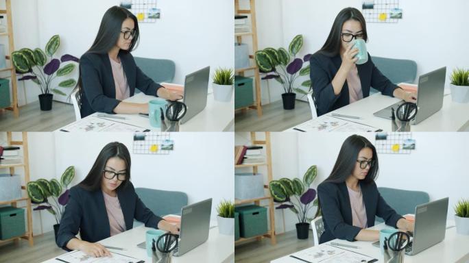 亚洲女孩员工穿着西装在办公室用笔记本电脑工作喝咖啡看文件