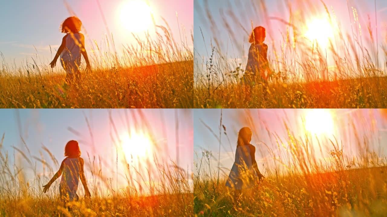 日落时分，SLO MO Girl在金色的草地上奔跑