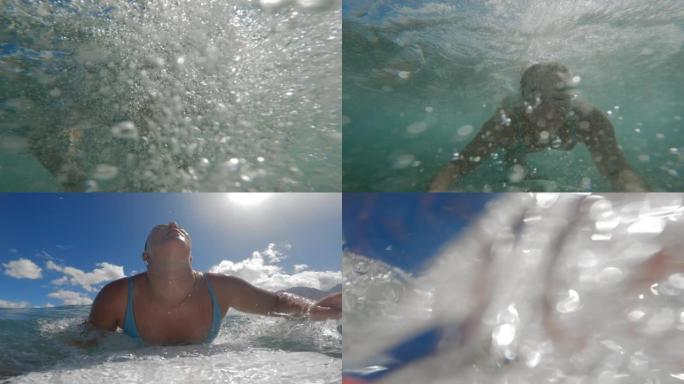 冲浪女孩鸭子在海浪撞击下潜水