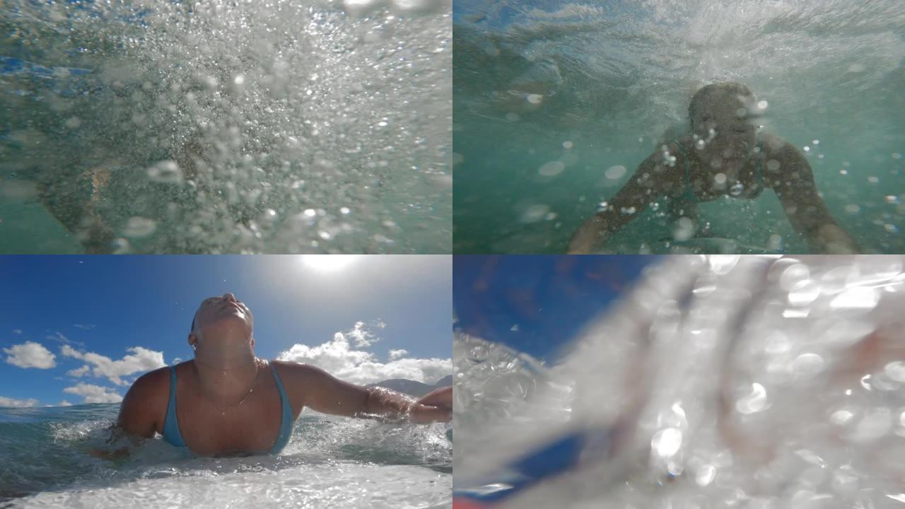 冲浪女孩鸭子在海浪撞击下潜水