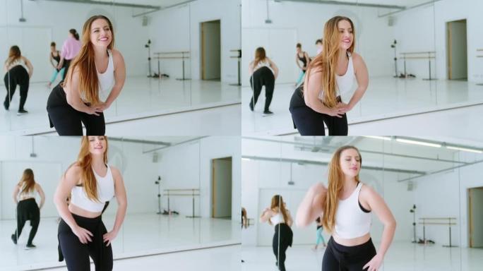 舞蹈教练在健身工作室上课做腿部伸展运动