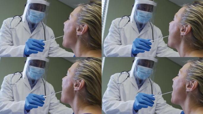 戴口罩的女性患者和医生在做covid拭子测试