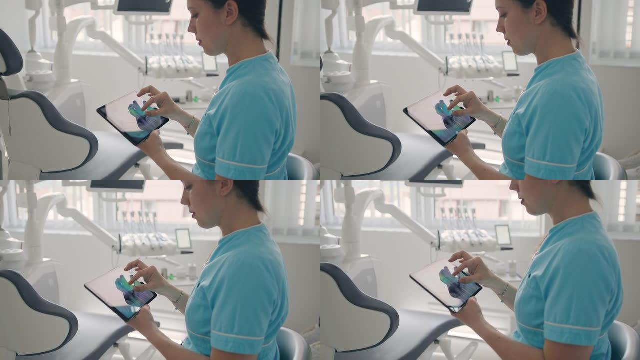 年轻的女牙医女士在数字平板电脑上看着人类的牙齿x射线