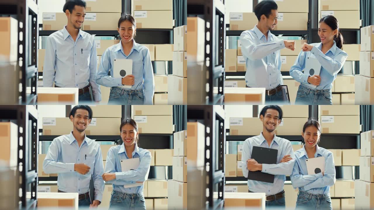 两个快乐的亚洲商业成功伙伴关系男女穿着制服衬衫携带数码平板电脑微笑看着仓库的相机。良好的合作效果，创