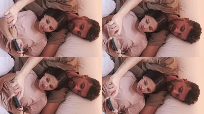 异性恋夫妇在床上使用智能手机