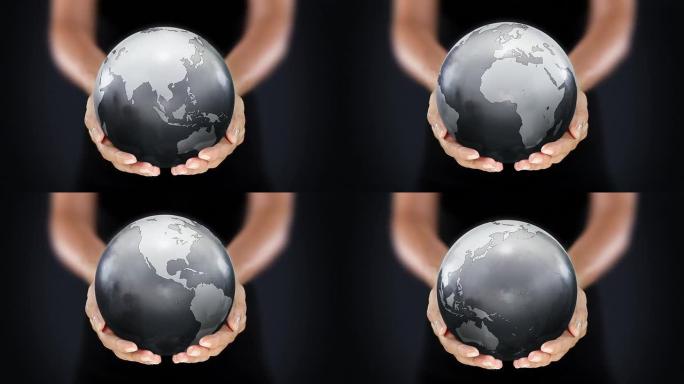 女性双手握着地球。从亚洲开始。灰色。