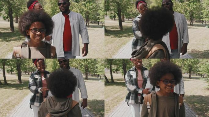 与父母一起散步的非裔美国男孩