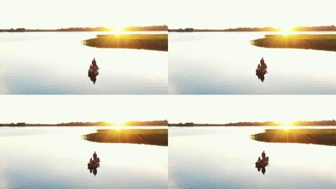 家庭联谊之旅。令人难以置信的背景全景，父母和孩子们一起在划船观看史诗般的湖日落。