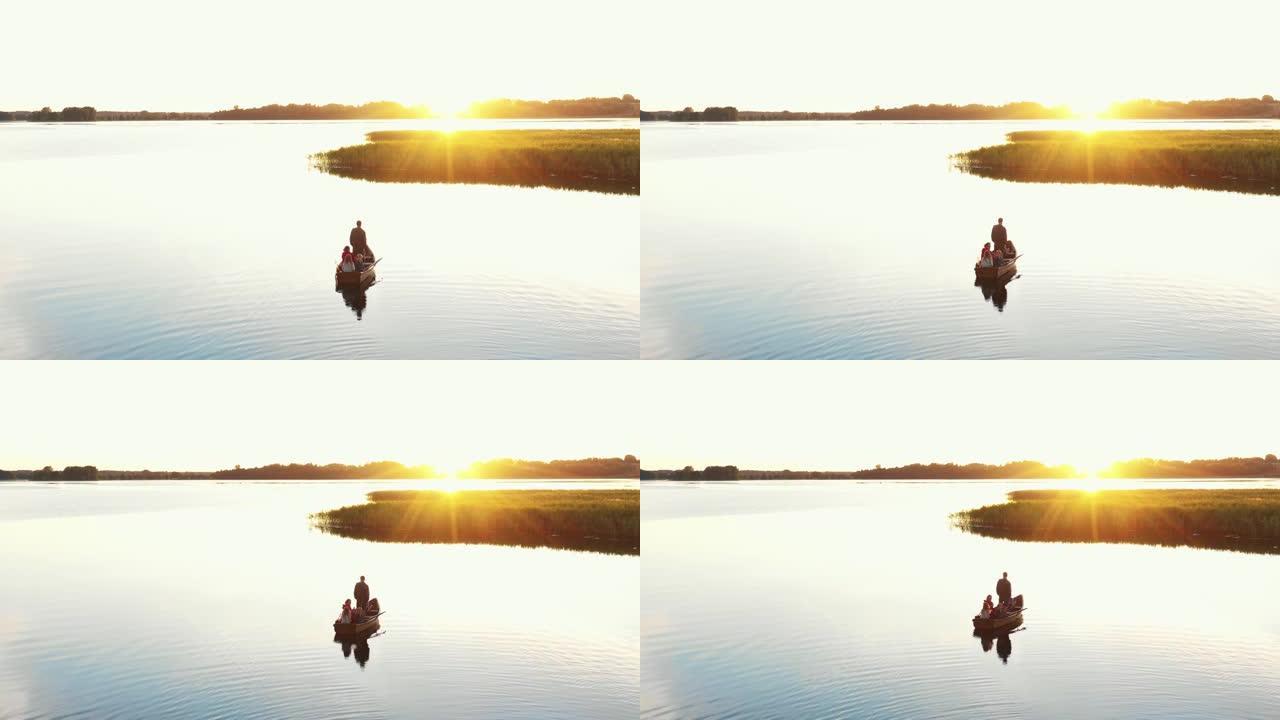 家庭联谊之旅。令人难以置信的背景全景，父母和孩子们一起在划船观看史诗般的湖日落。