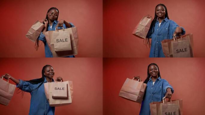 一位年轻的黑皮肤博客作者展示了她的购物袋，享受着成功的销售购物