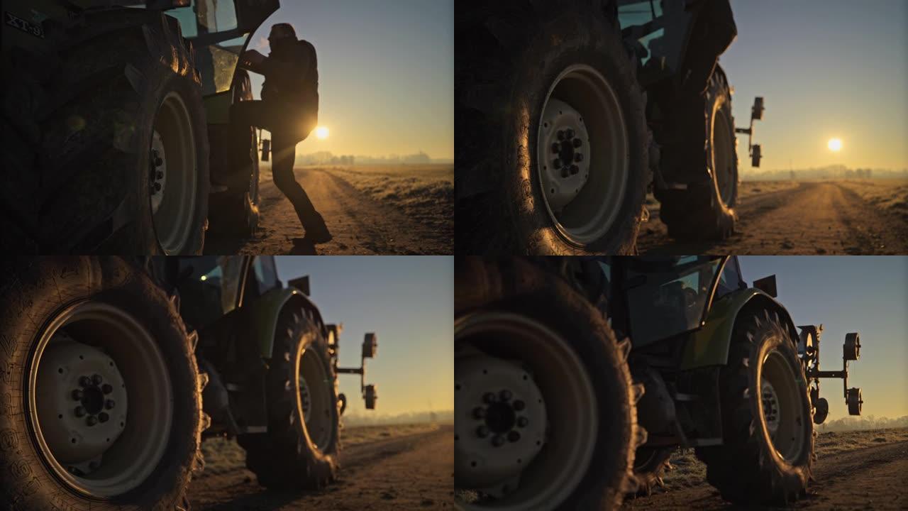 男性农民在日出时爬进农村的拖拉机