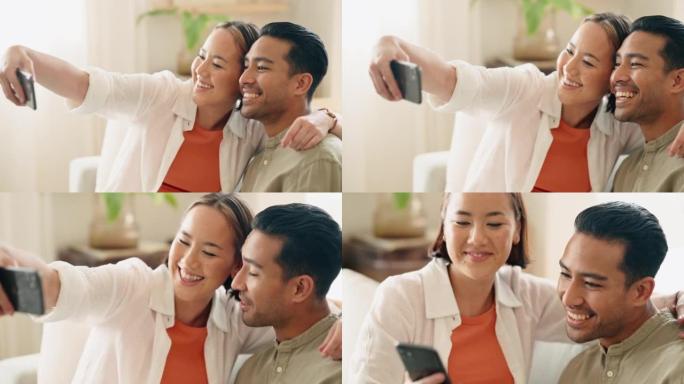 自拍，智能手机和亚洲夫妇在客厅进行家庭摄影，社交媒体更新或关于一起生活的博客文章。手机肖像沙发上的快