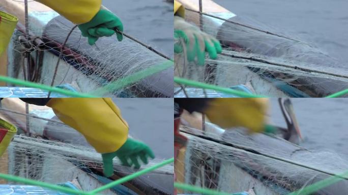 智利瓦尔帕莱索附近的船上渔夫手里拿着网。特写。