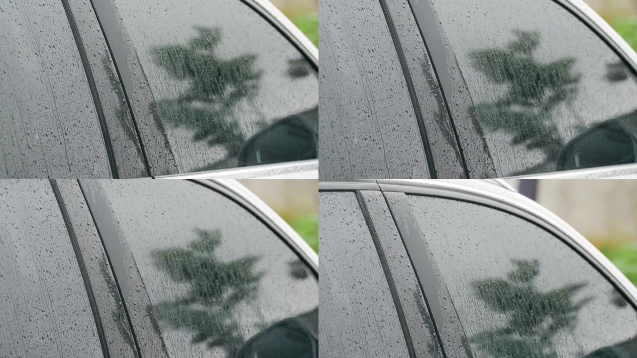 下雨天的特写车车窗上的雨水玻璃上的雨滴雨