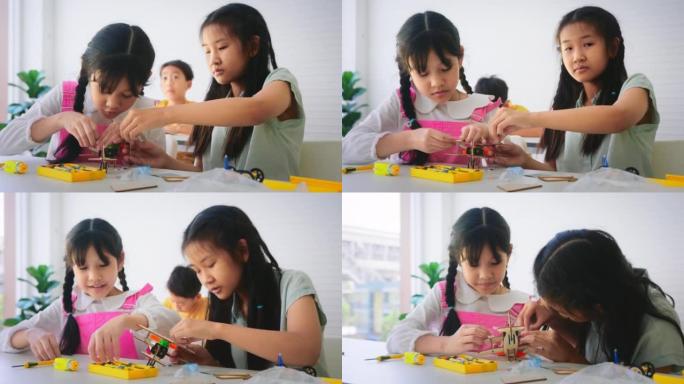 学习机器人编程和算法思维培训班的小学生特写小组。小学教育STEM教育概念。