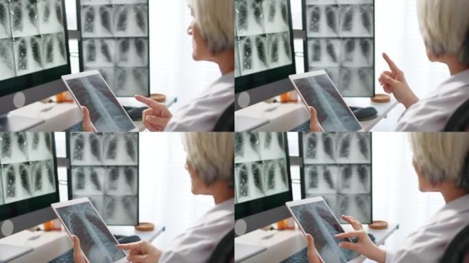 高级女医生向患者看平板电脑上的肺部扫描
