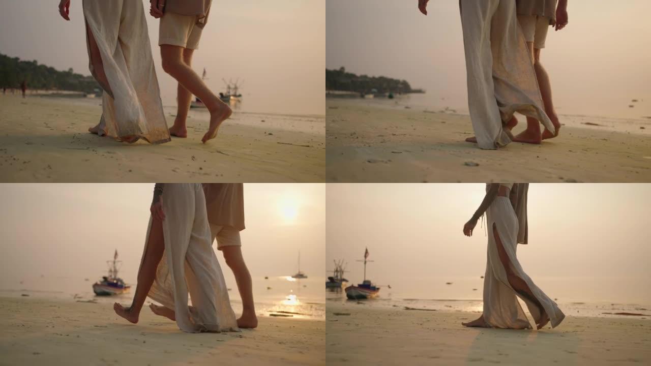日落漫步中的夫妇大长腿步伐散步漫步海滩