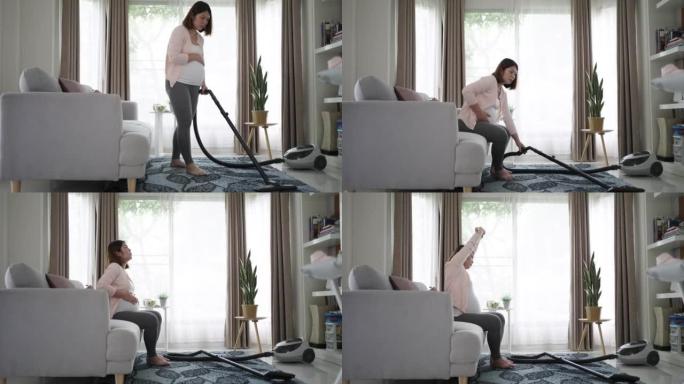 孕妇使用吸尘器清洁客厅