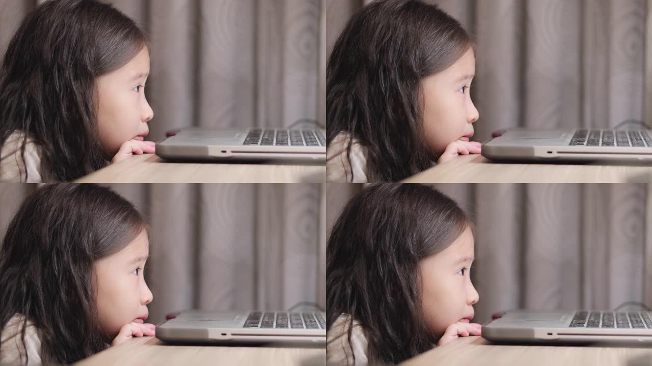 快乐可爱小女孩看平板电脑的CU特写脸