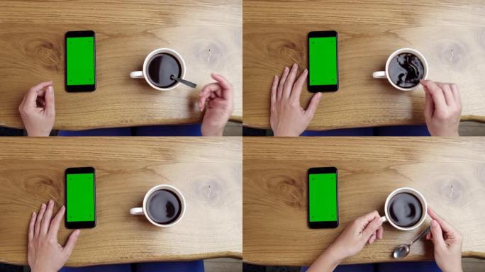 女士无法辨认的女人使用带有色度键绿屏的智能手机，同时用勺子搅拌咖啡