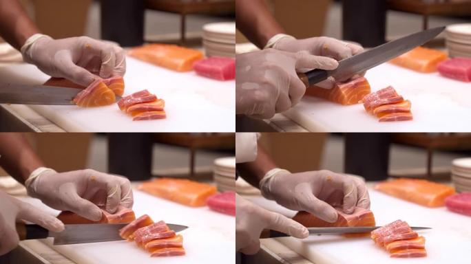 4K UHD慢动作手持: 关闭厨师的手切生鲑鱼作为生鱼片，日本美食。