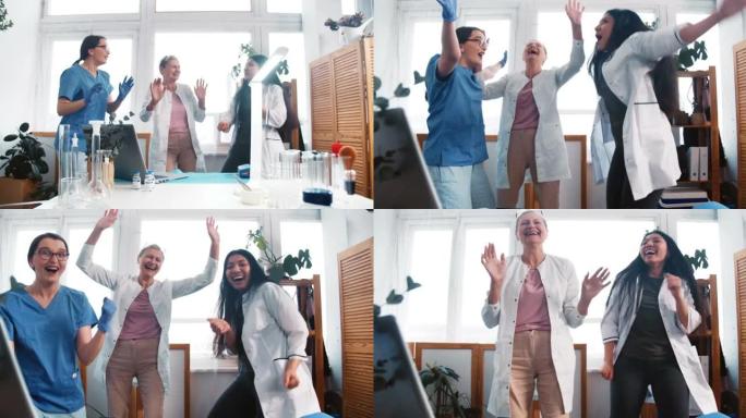 抗击新型冠状病毒肺炎大流行的结束。三位快乐开朗的多民族女医生跳舞庆祝工作取得巨大成功
