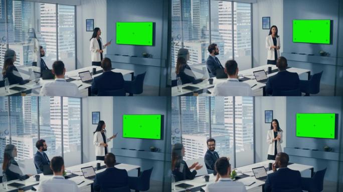 办公室会议室会议演讲: 亚洲女商人演讲，使用绿屏色键墙电视。成功地向不同的投资者群体展示产品。商人鼓