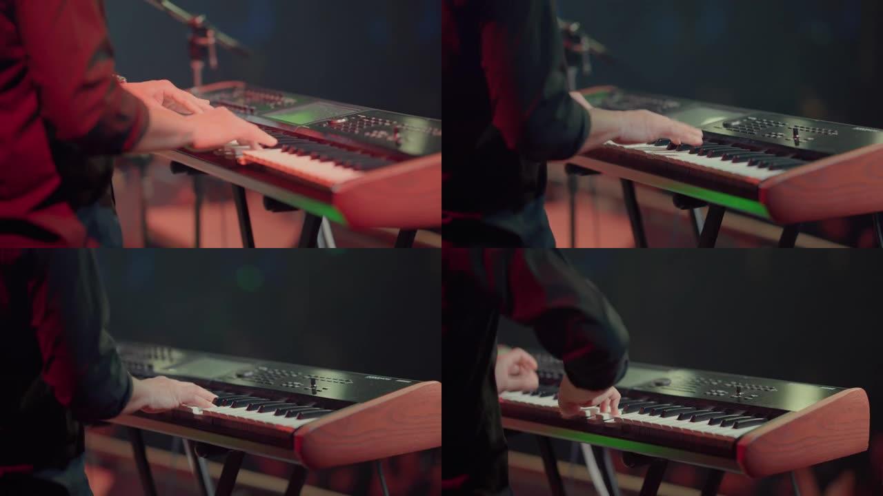 摇滚乐队音乐家在音乐节上演奏钢琴的特写镜头。