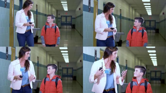 小学生与老师在学校走廊散步