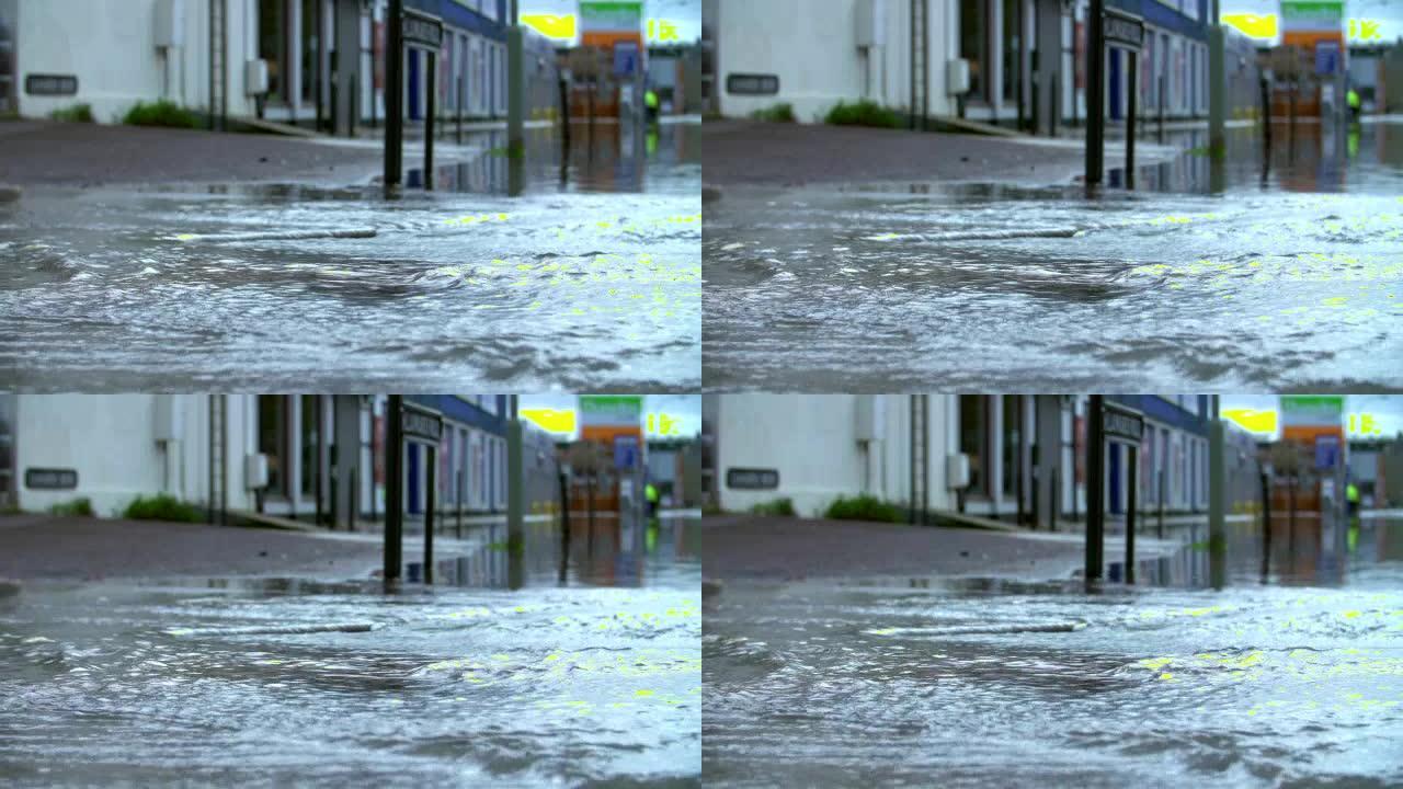 惠灵顿靴子在洪水泛滥的道路上行走的慢动作序列