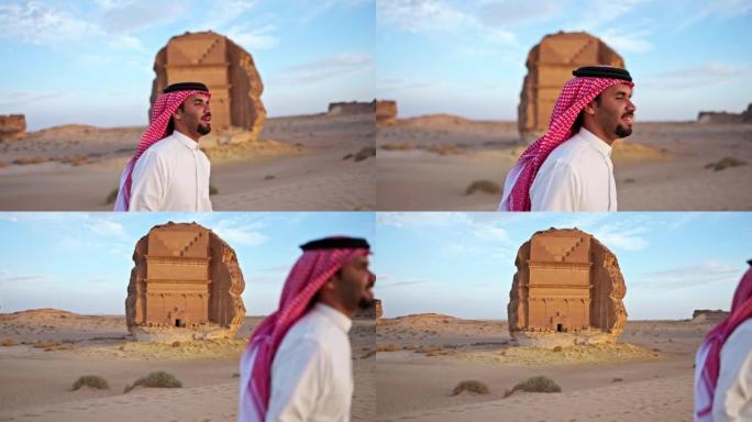 20多岁的沙特男子参观了Hegra的岩石坟墓