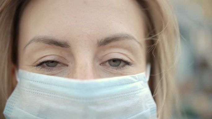 现代年轻护士戴防护医用口罩和看的特写肖像。概念安全和眼睛女性患者在检疫的社会距离。慢动作4k的视线人