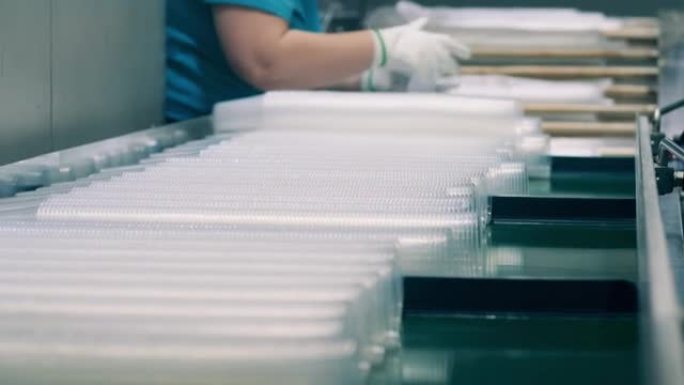 工厂工人用玻璃纸包裹的塑料杯
