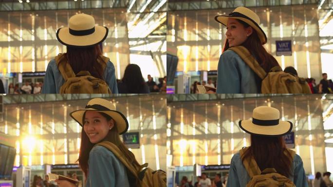 在候机楼机场门口行走的年轻休闲女子。年轻女子独自乘飞机旅行。