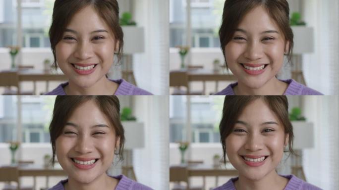 肖像迷人的亚洲女性影响者视频博客对着镜头微笑。