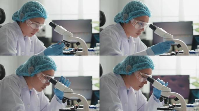 科学家在实验室用显微镜研究小细胞