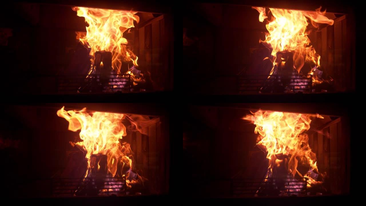 特写: 在黑暗房间中间燃烧的大火的电影镜头。