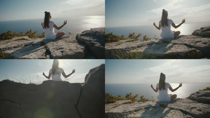 在悬崖上冥想的年轻女子的风景